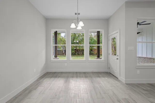 a view of kitchen with stove refrigerator and microwave