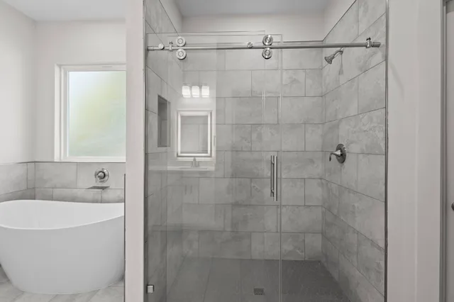 a bathroom that has a glass shower door