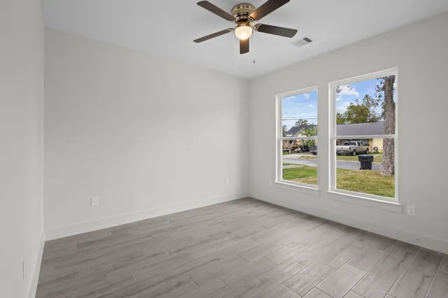 an empty room with windows and closet
