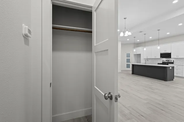 a large kitchen with kitchen island granite countertop a large counter top stainless steel appliances and cabinets