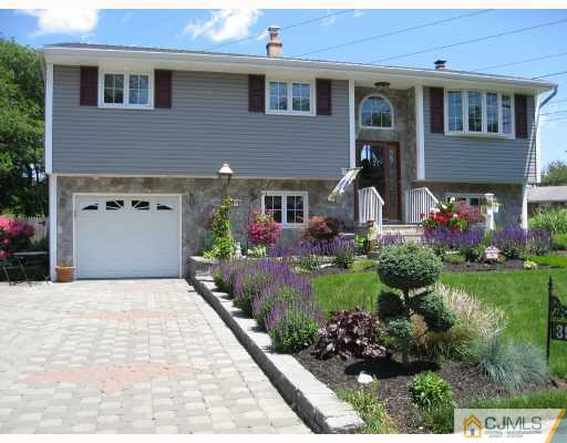 a front view of a house with a yard and outdoor seating