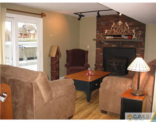 39 Warrenville Road Middlesex, NJ 08846 - Photo 11 of 23 a living room with furniture a table and a fireplace