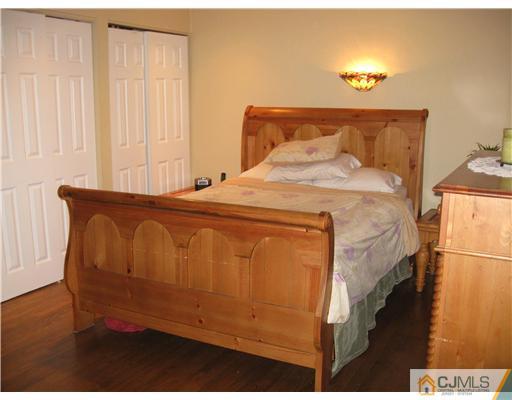 39 Warrenville Road Middlesex, NJ 08846 - Photo 13 of 23 a bed sitting in a bedroom next to a window