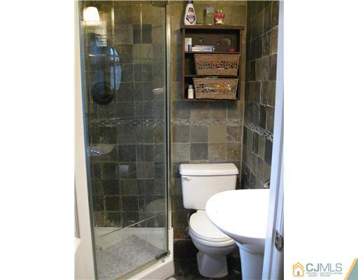 39 Warrenville Road Middlesex, NJ 08846 - Photo 14 of 23 a bathroom with a toilet and a shower