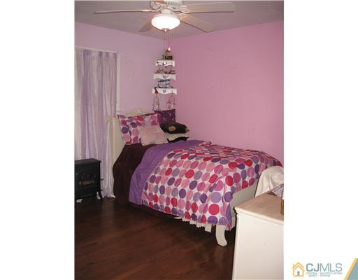 39 Warrenville Road Middlesex, NJ 08846 - Photo 17 of 23 a bedroom with a bed and a chandelier