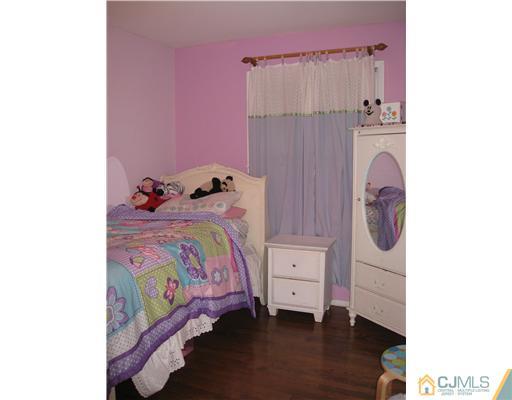 39 Warrenville Road Middlesex, NJ 08846 - Photo 19 of 23 a bedroom with a bed and a mirror