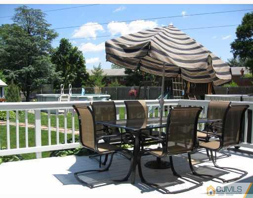 39 Warrenville Road Middlesex, NJ 08846 - Photo 21 of 23 a view of a chairs and tables in the back yard of the house