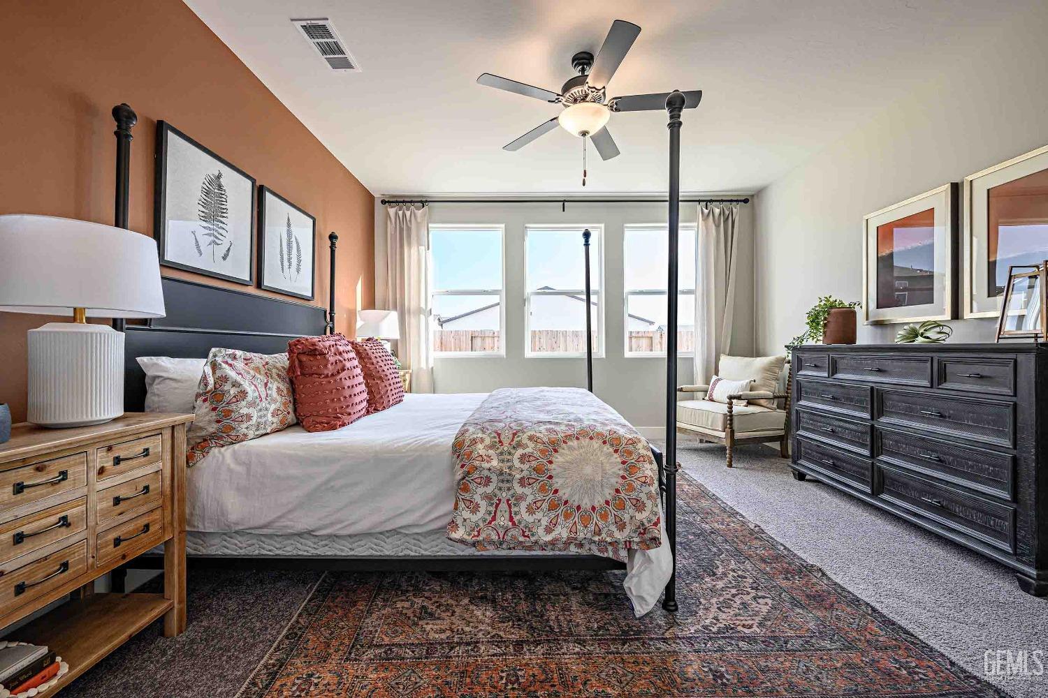 Undisclosed Address Bakersfield, CA 93313 - Photo 12 of 27 a bedroom with a bed a chandelier and a dresser