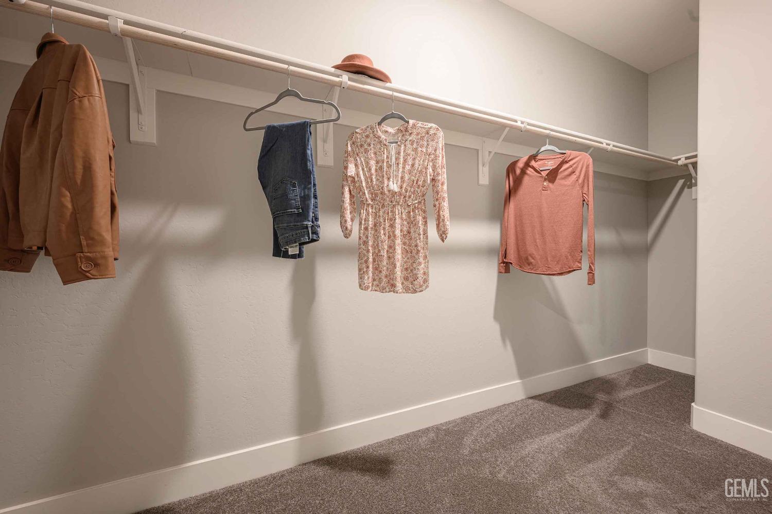 Undisclosed Address Bakersfield, CA 93313 - Photo 19 of 27 a view of walk in closet with clothes and shoes