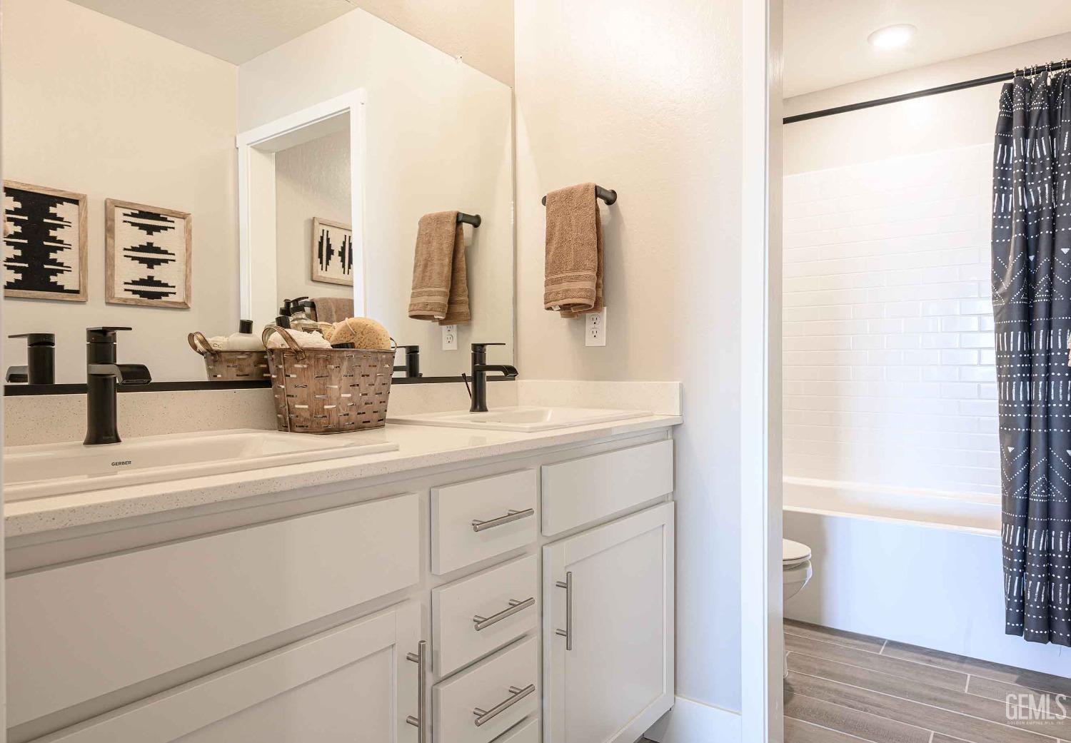 Undisclosed Address Bakersfield, CA 93313 - Photo 20 of 27 a bathroom with a double vanity sink and a mirror