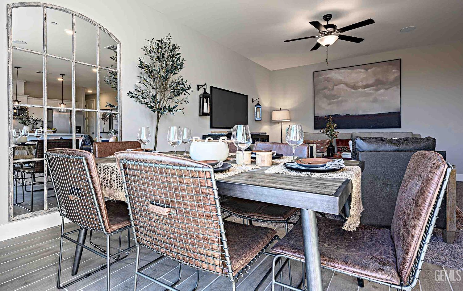 Undisclosed Address Bakersfield, CA 93313 - Photo 6 of 27 a dining room with furniture potted plants and wooden floor