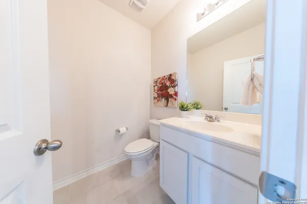 a bathroom with a sink toilet and mirror