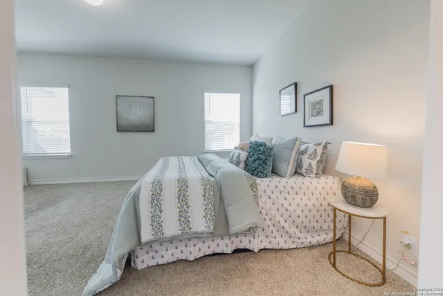 a living room with a bed and furniture