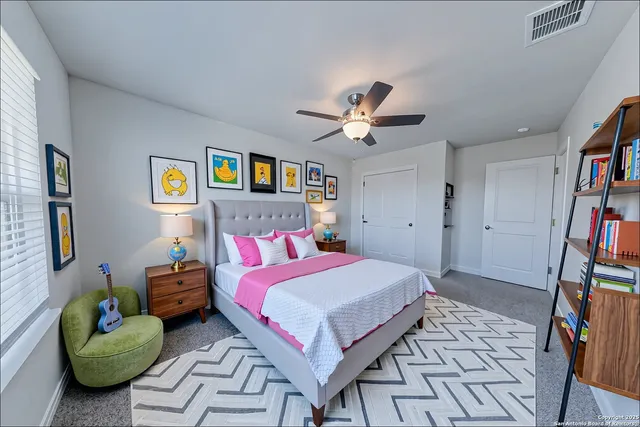 a bedroom with a bed and a book shelf