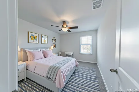 a bedroom with a large bed and a window