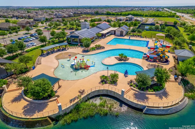 an aerial view of a swimming pool patio swimming pool and outdoor seating
