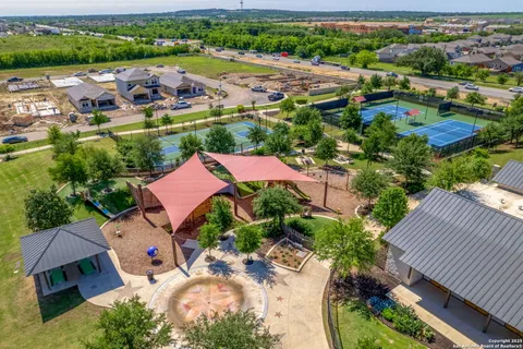 an aerial view of residential houses with outdoor space and street view