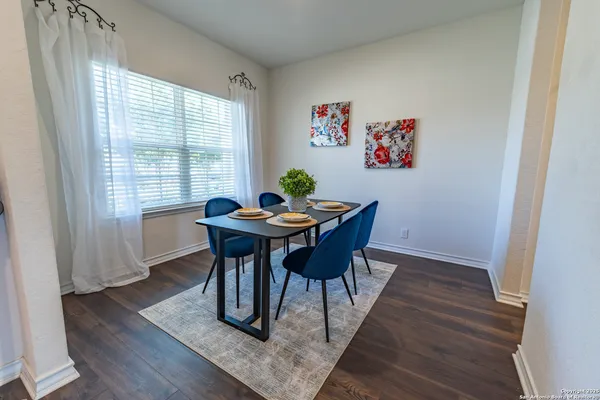 a view of a dining room with furniture window and wooden floor