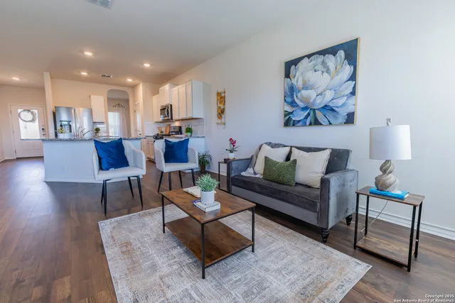 a living room with furniture and a wooden floor