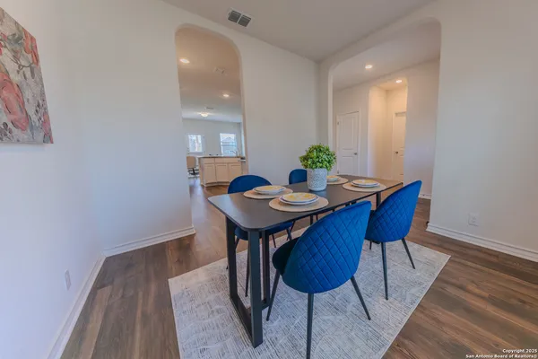 a view of a dining room with furniture and wooden floor