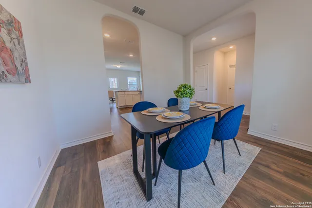 a view of a dining room with furniture and wooden floor