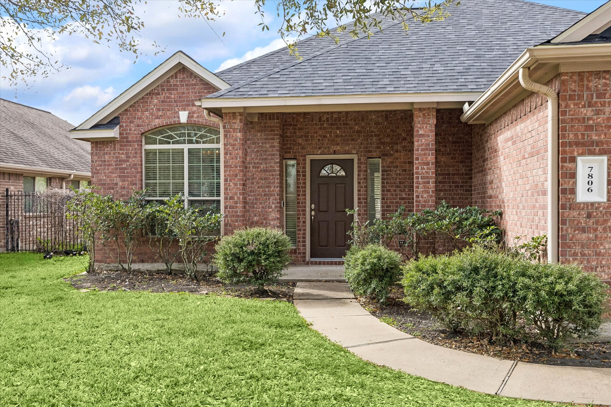 7806 Summer Night Lane Rosenberg, TX 77469 - Photo 2 of 23 The front yard features established landscaping and mature trees providing shade across the lawn and entry walkway.