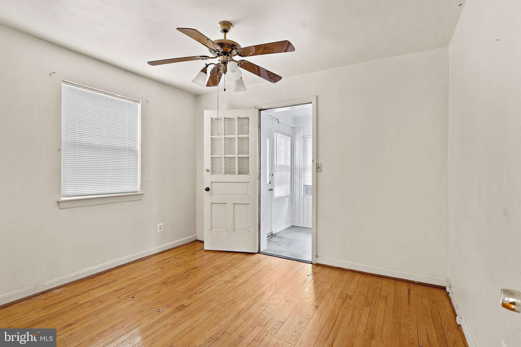 5913 Rolston Road Bethesda, MD 20817 - Photo 14 of 37 a view of empty room with wooden floor and fan