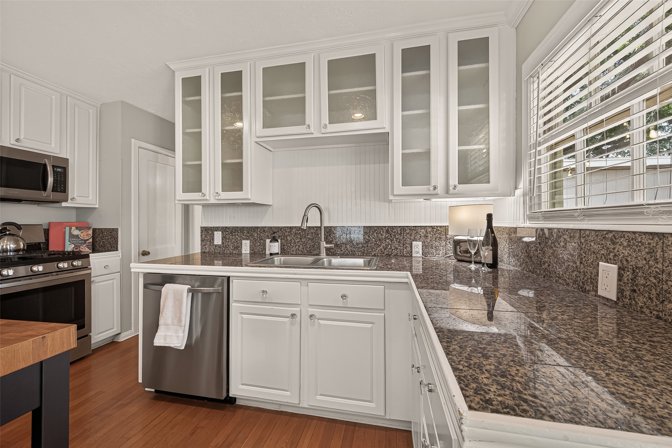 2019 Gostick Street Houston, TX 77008 - Photo 19 of 36 a kitchen with stainless steel appliances granite countertop a stove a sink and a microwave
