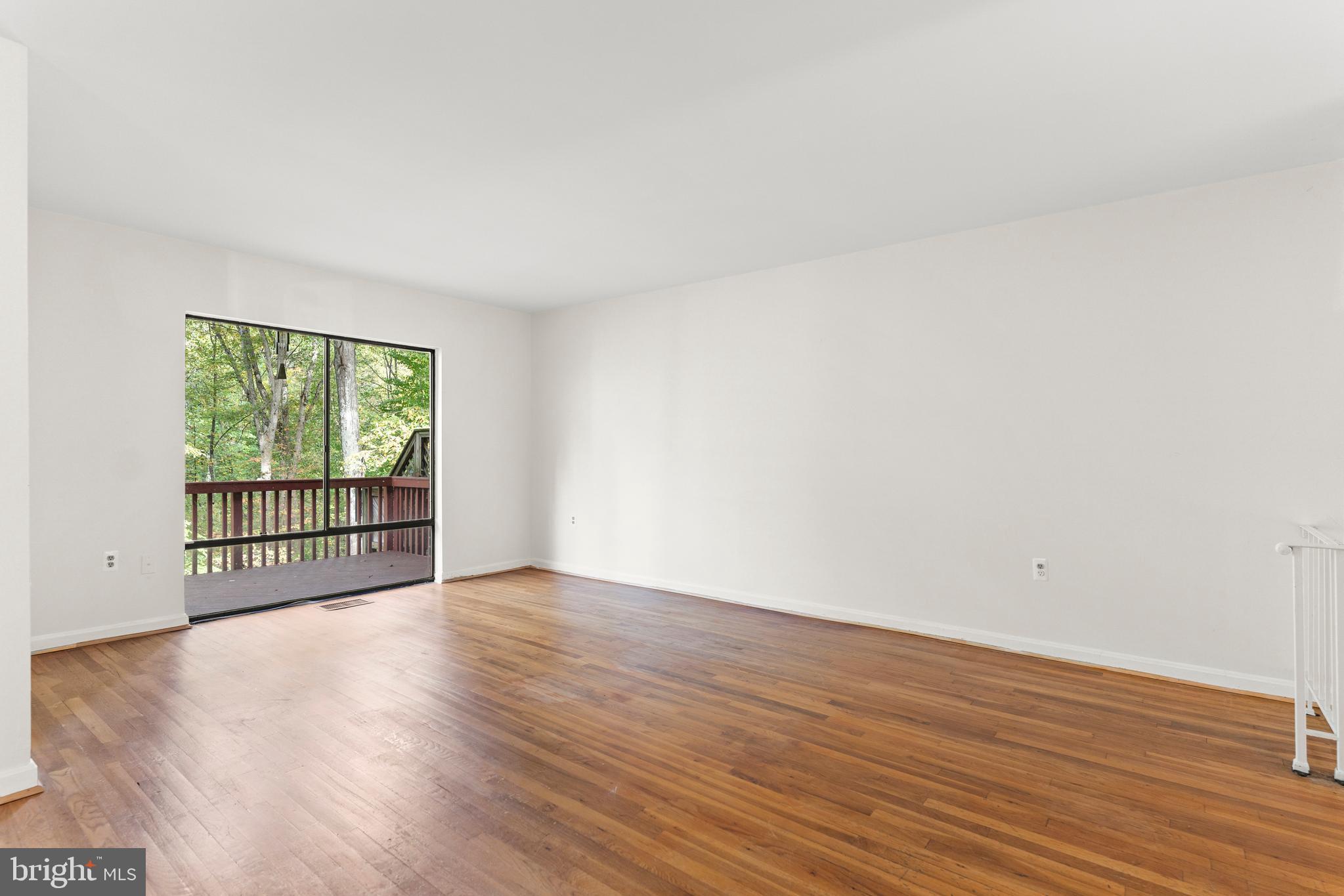 7911 Inverness Ridge Road Potomac, MD 20854 - Photo 11 of 45 a view of an empty room with wooden floor and a window