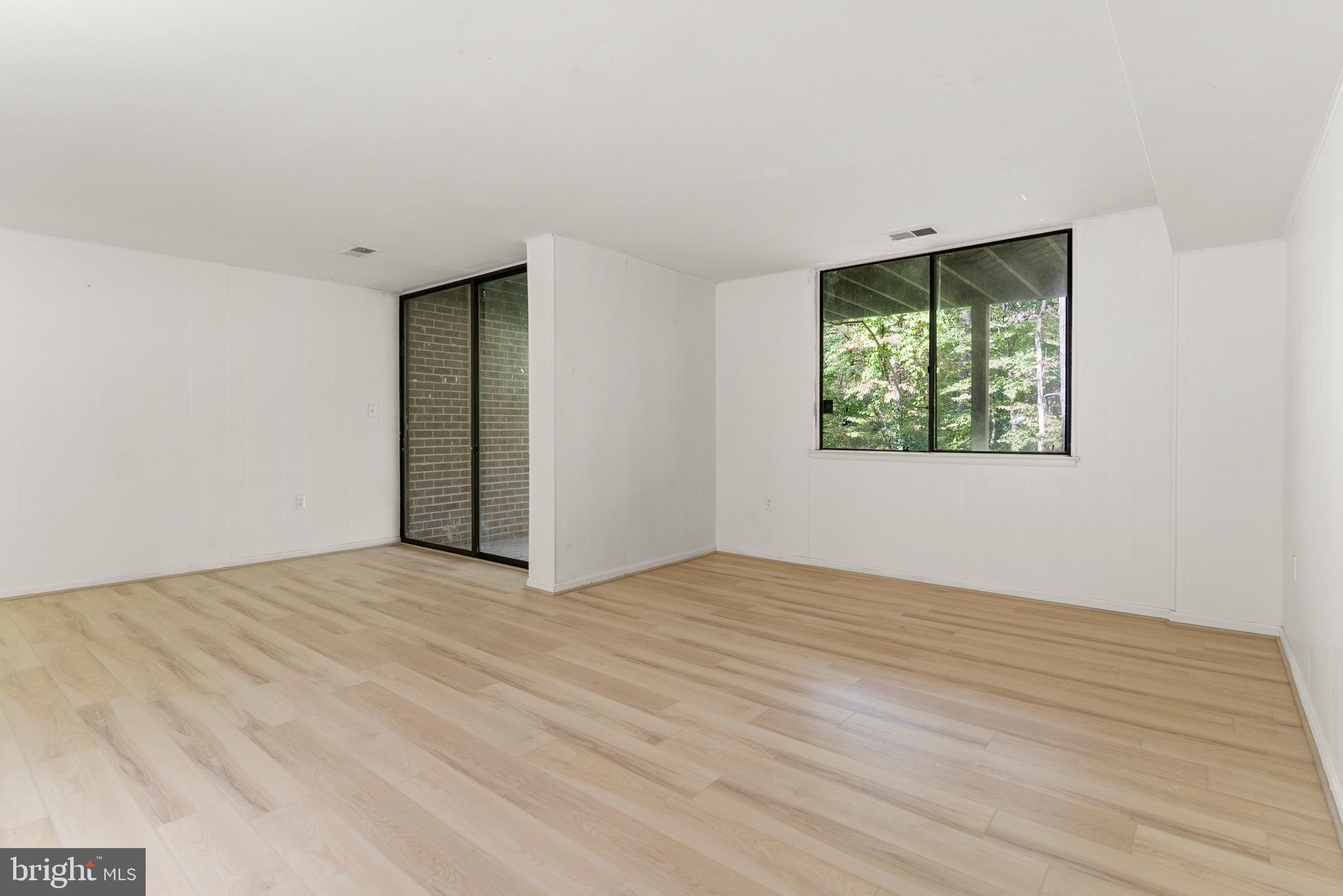 7911 Inverness Ridge Road Potomac, MD 20854 - Photo 14 of 45 a view of an empty room with wooden floor and a window