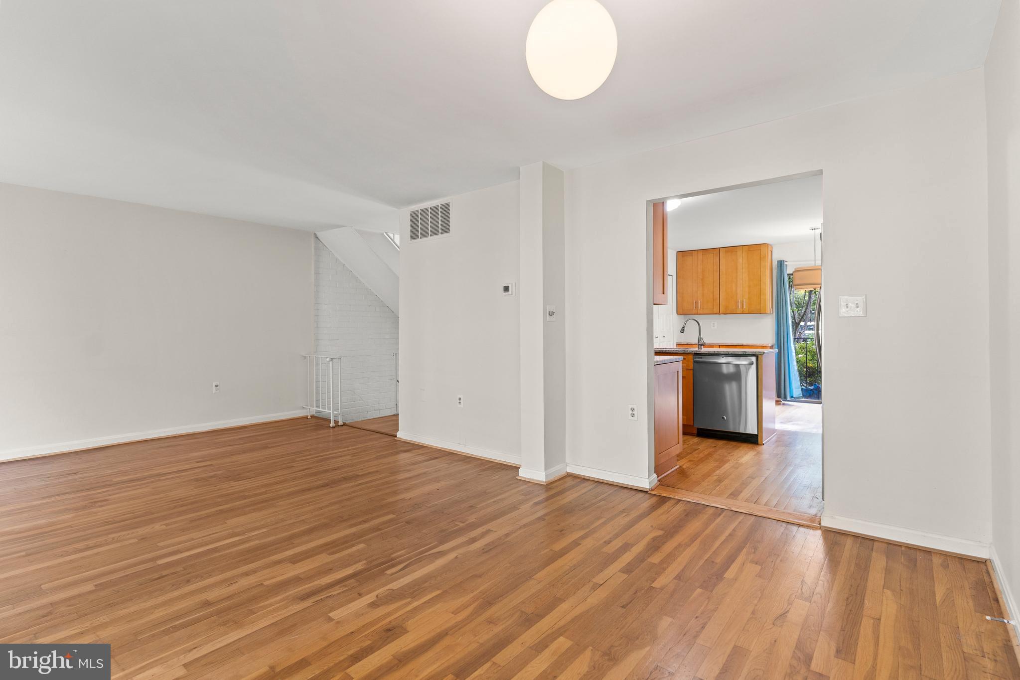 7911 Inverness Ridge Road Potomac, MD 20854 - Photo 17 of 45 a view of empty room with wooden floor and kitchen
