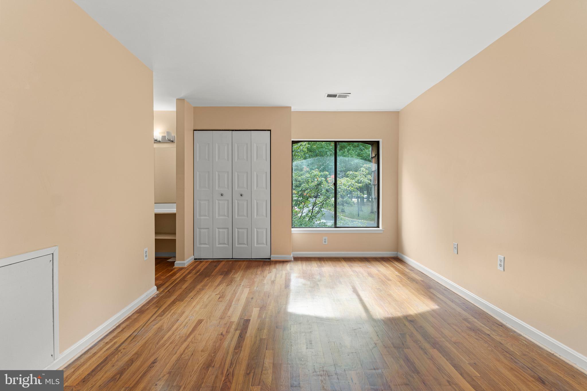 7911 Inverness Ridge Road Potomac, MD 20854 - Photo 19 of 45 an empty room with wooden floor and windows