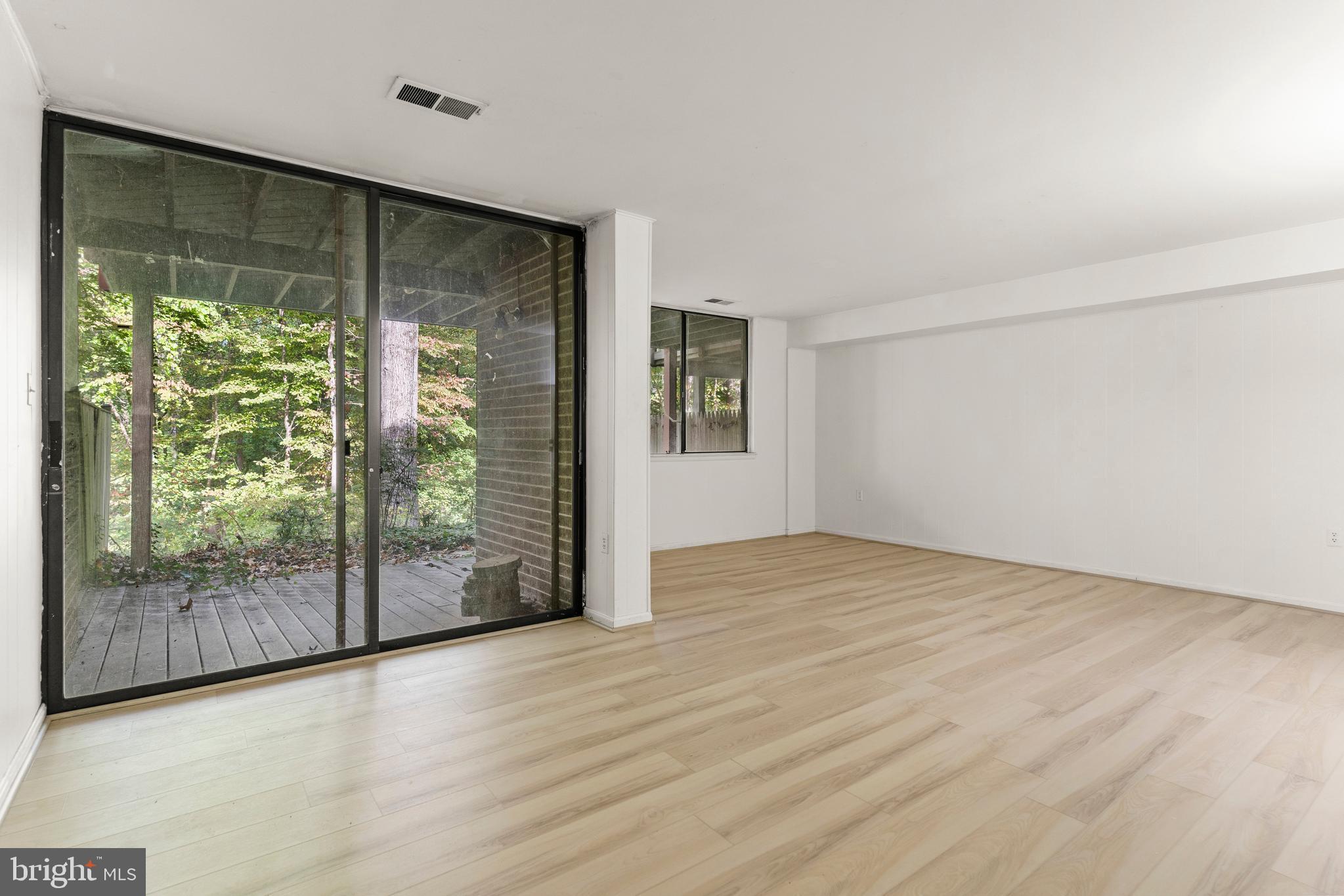 7911 Inverness Ridge Road Potomac, MD 20854 - Photo 22 of 45 a view of an empty room with wooden floor and a window