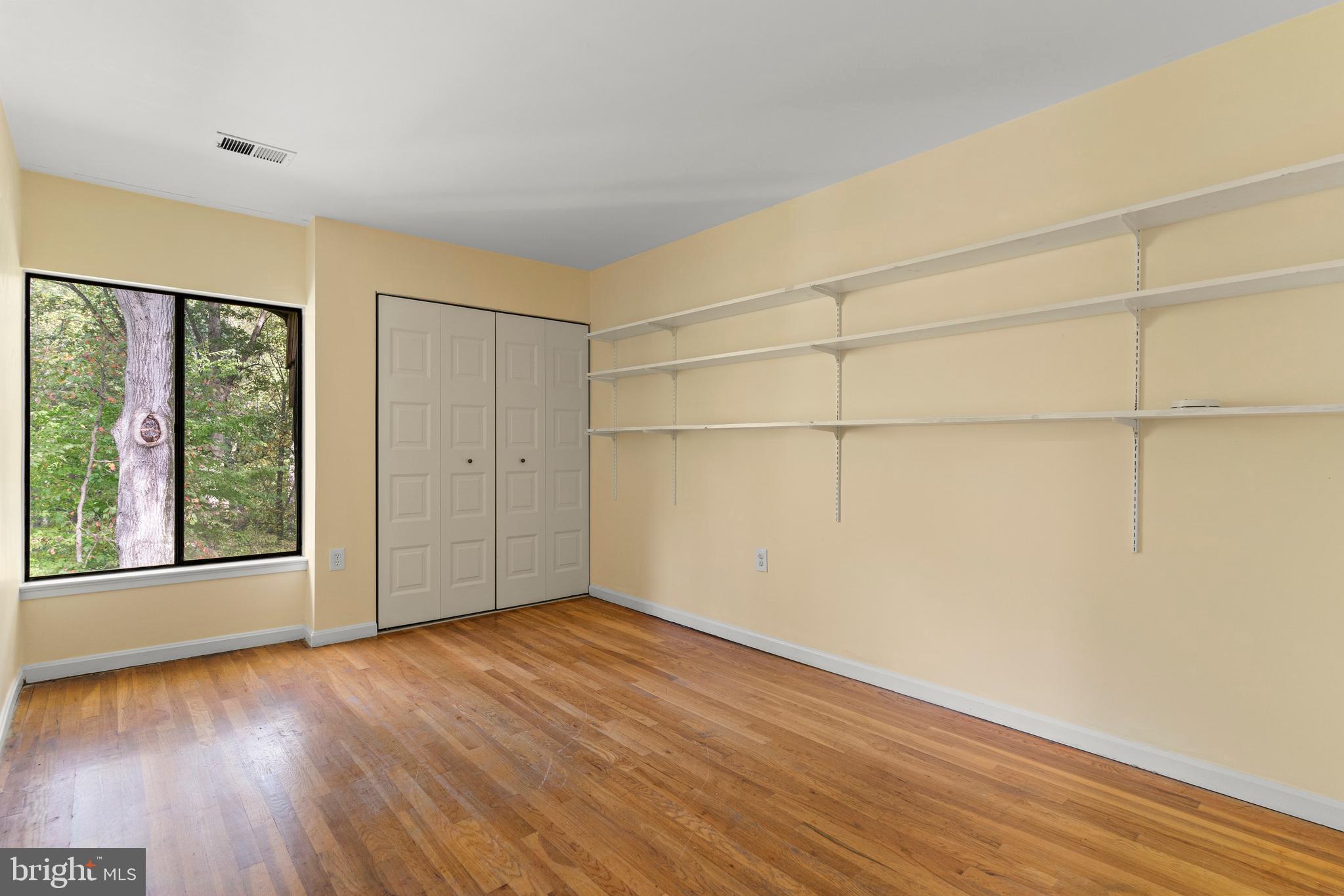 7911 Inverness Ridge Road Potomac, MD 20854 - Photo 23 of 45 wooden floor in an empty room with a window