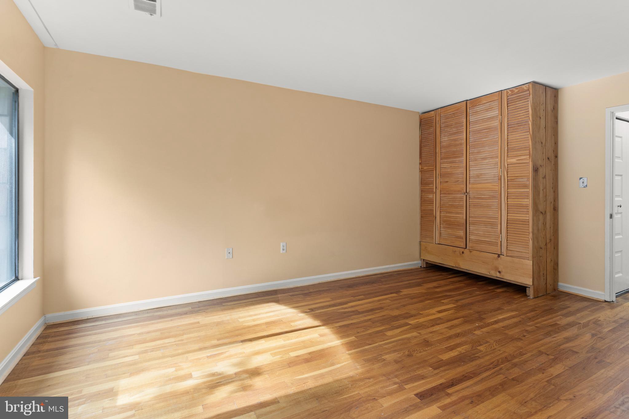7911 Inverness Ridge Road Potomac, MD 20854 - Photo 24 of 45 a view of an empty room with wooden floor and closet