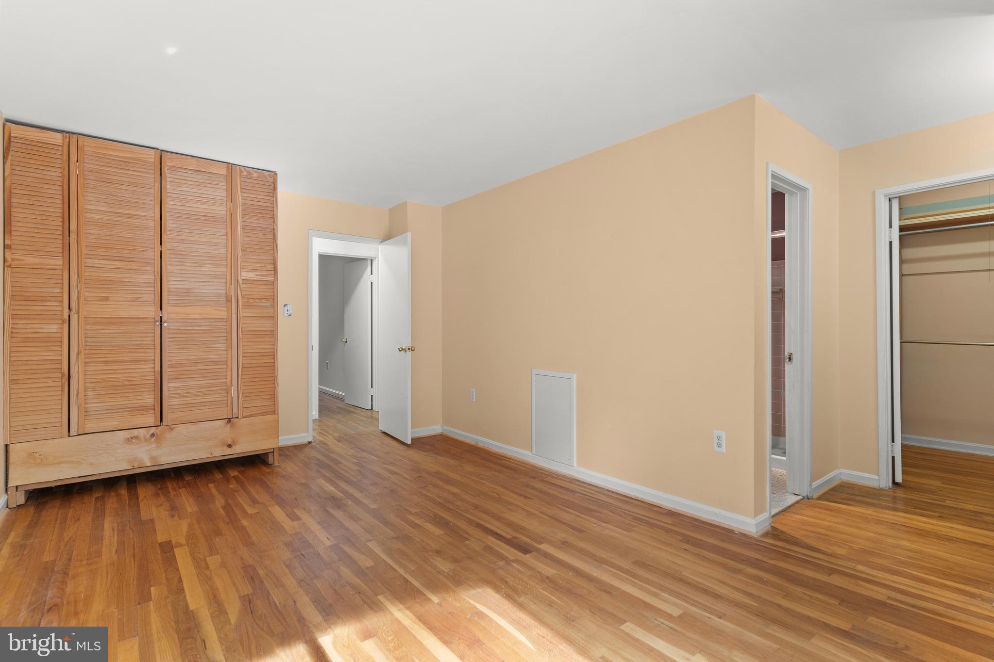 7911 Inverness Ridge Road Potomac, MD 20854 - Photo 25 of 45 a view of an empty room with wooden floor and a window