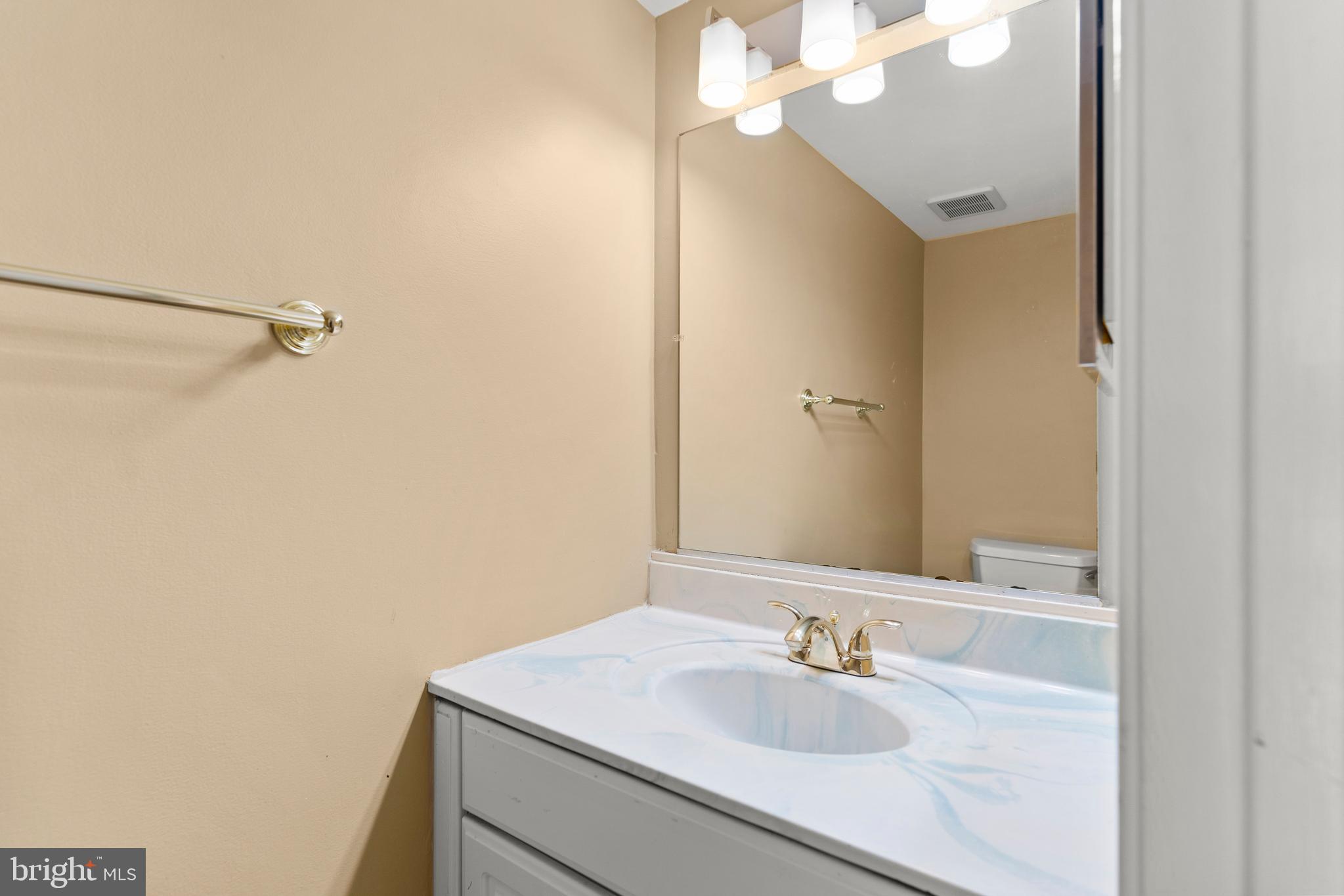 7911 Inverness Ridge Road Potomac, MD 20854 - Photo 26 of 45 a bathroom with a sink and a mirror