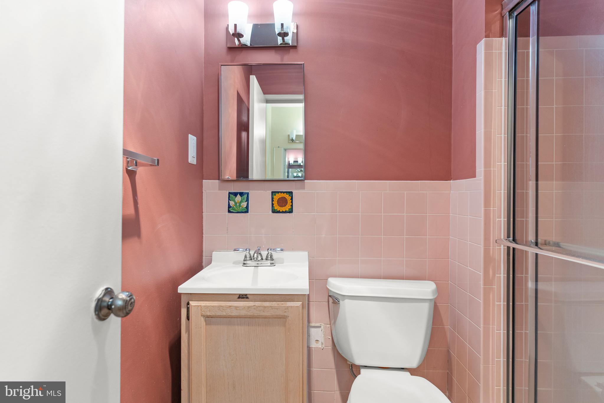 7911 Inverness Ridge Road Potomac, MD 20854 - Photo 29 of 45 a bathroom with a toilet sink and mirror