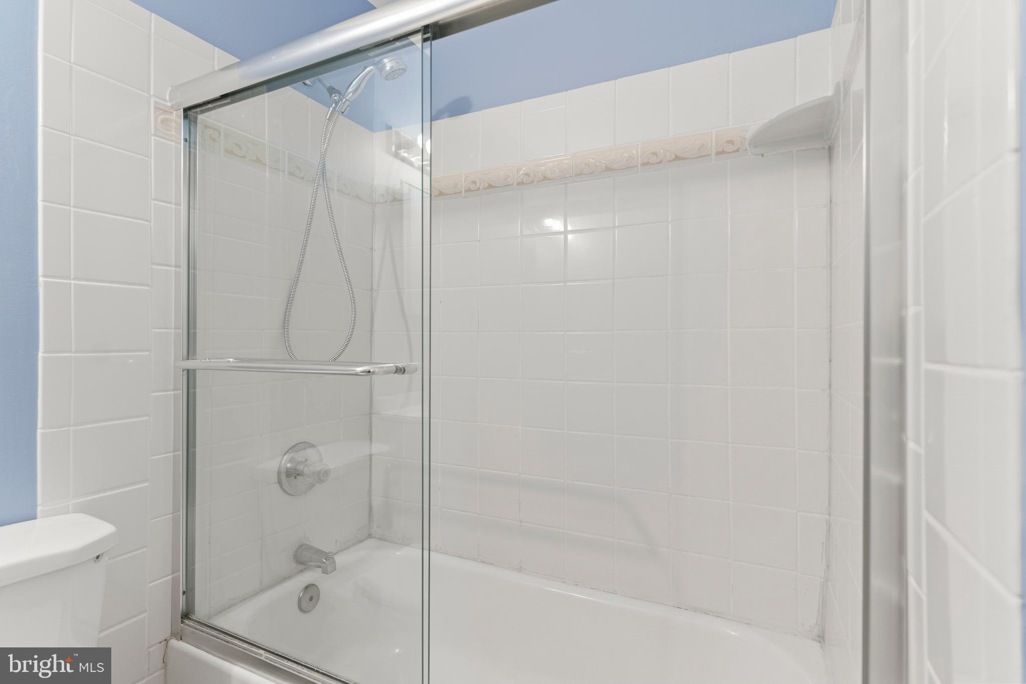 7911 Inverness Ridge Road Potomac, MD 20854 - Photo 33 of 45 a bathroom with a shower and a toilet