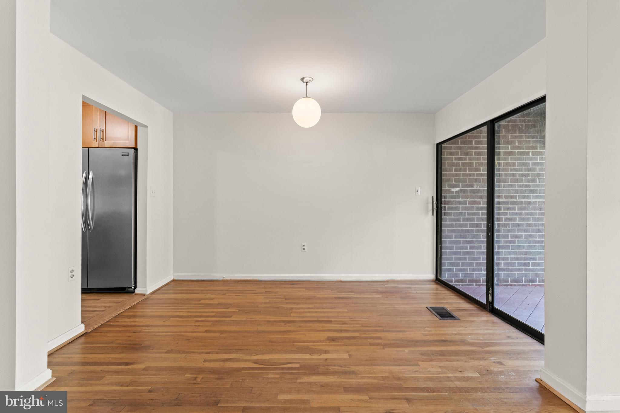 7911 Inverness Ridge Road Potomac, MD 20854 - Photo 36 of 45 a view of an empty room with wooden floor and a window