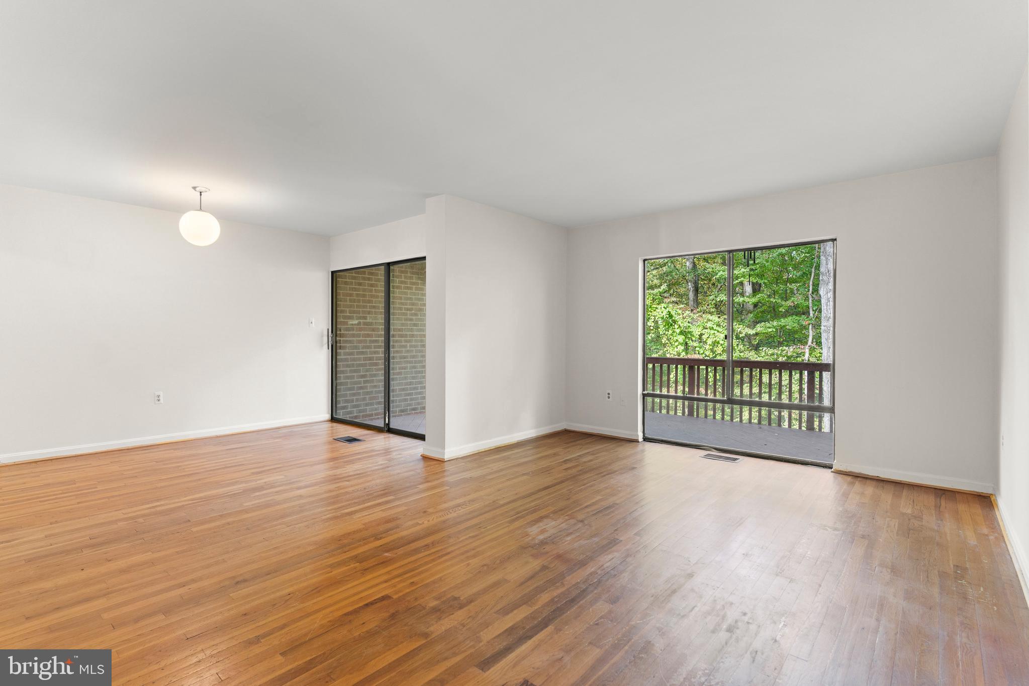 7911 Inverness Ridge Road Potomac, MD 20854 - Photo 37 of 45 a view of an empty room with wooden floor and a window