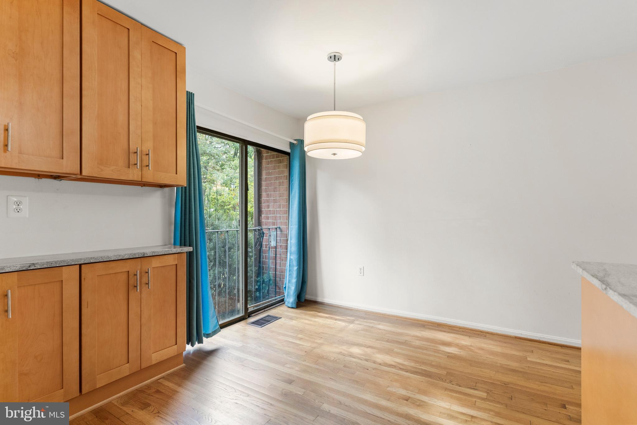 7911 Inverness Ridge Road Potomac, MD 20854 - Photo 7 of 45 an empty room with wooden floor and windows