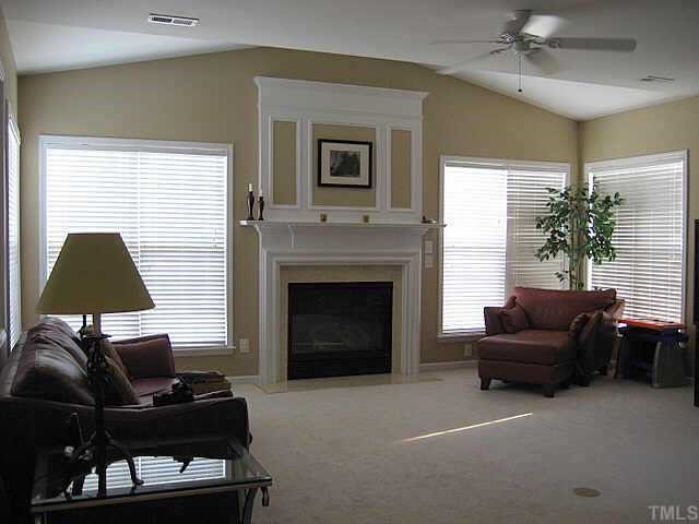 7552 Silver View Lane Raleigh, NC 27613 - Photo 4 of 10 a living room with furniture and a fireplace