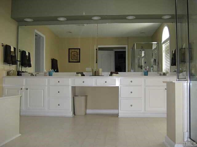 7552 Silver View Lane Raleigh, NC 27613 - Photo 7 of 10 a bathroom with a sink vanity and mirror