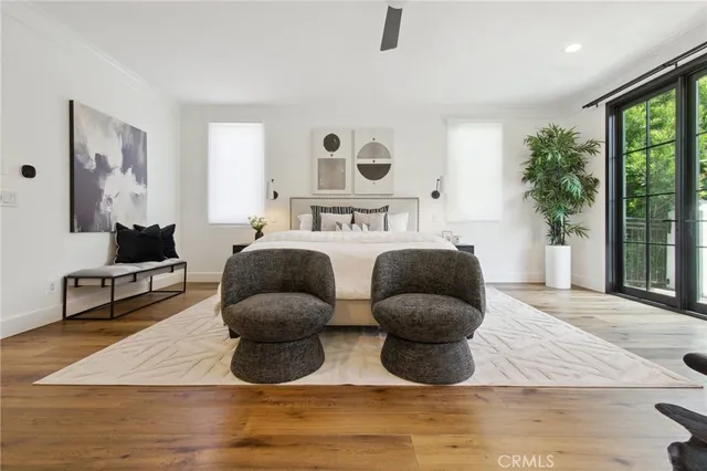 a bedroom with furniture and a large window