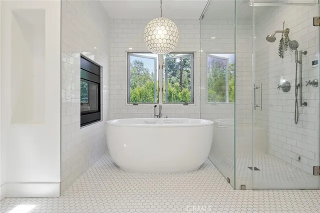 a white bath tub sitting in a bathroom next to a window