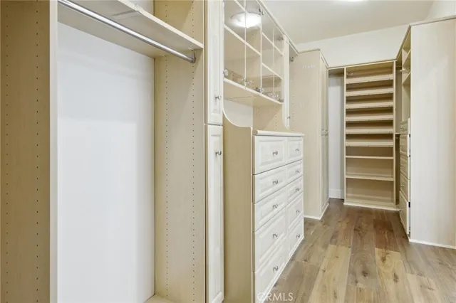 a view of walk in closet with empty racks