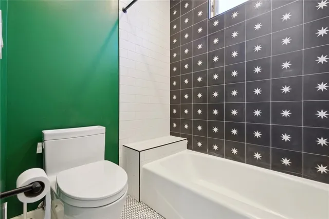 a white toilet sitting next to a bathroom sink