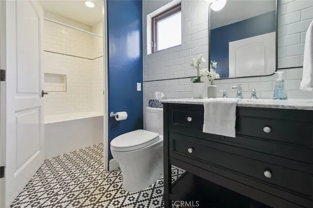 a bathroom with a sink a toilet and mirror