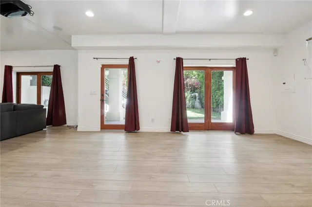 an empty room with windows and closet